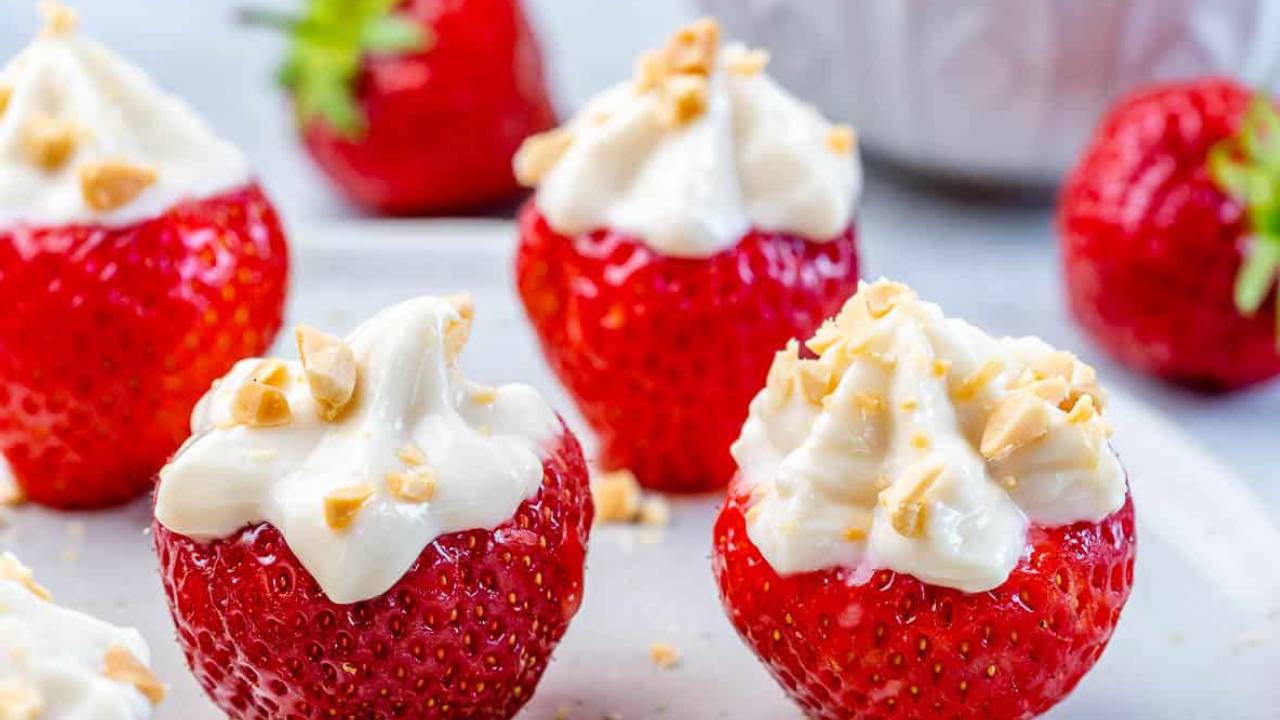 strawberry stuffed with cheesecake with peanuts on top
