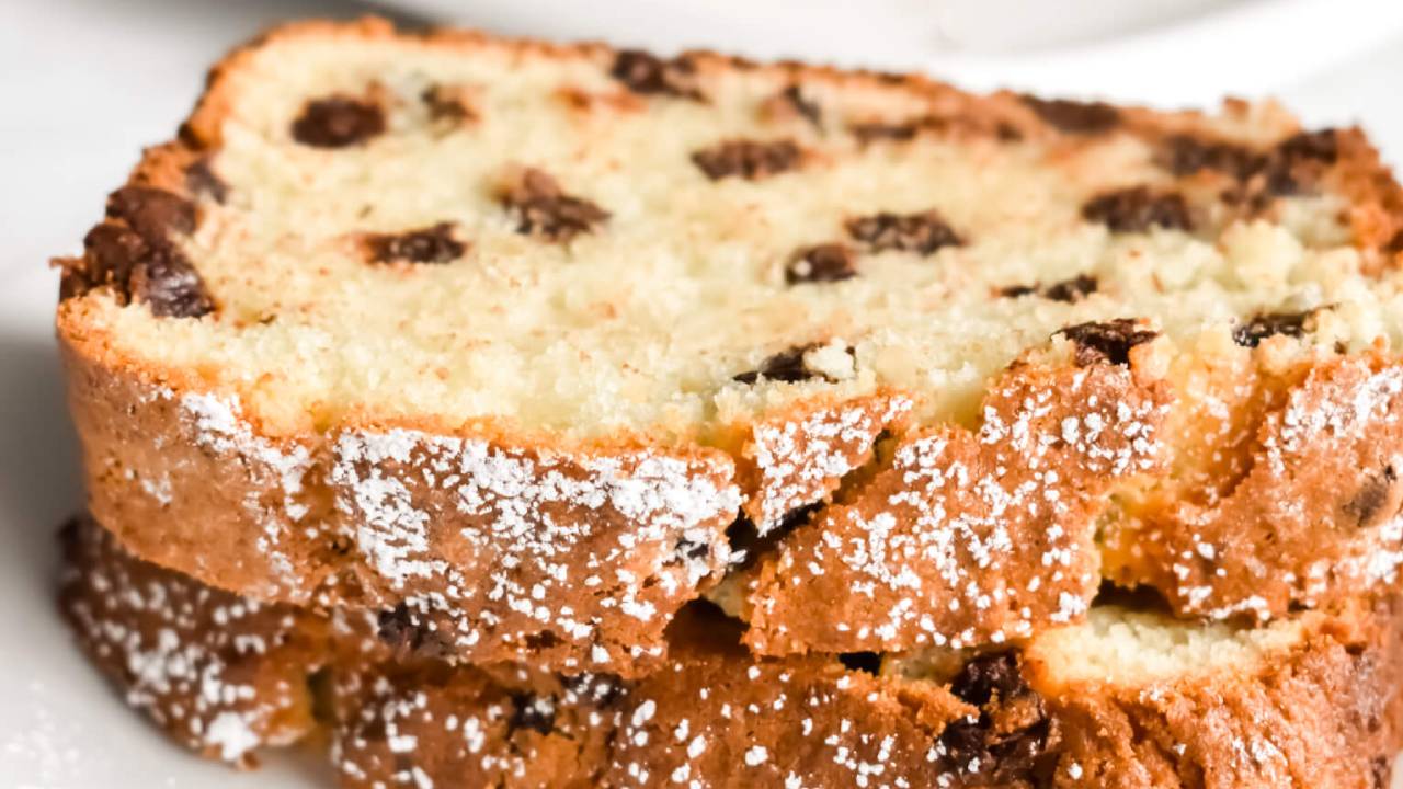 chocolate chip ricotta cake with powdered sugar on a plate