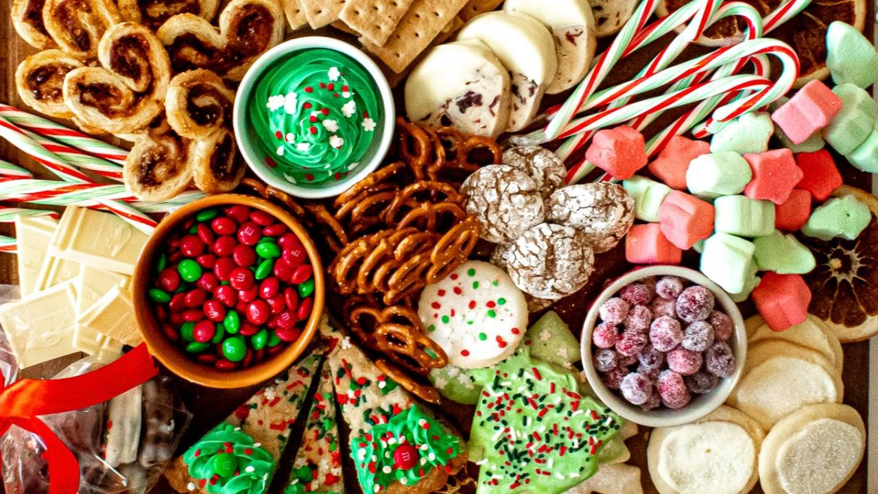 beautiful christmas charcuterie board with candies, cookies, pretzels