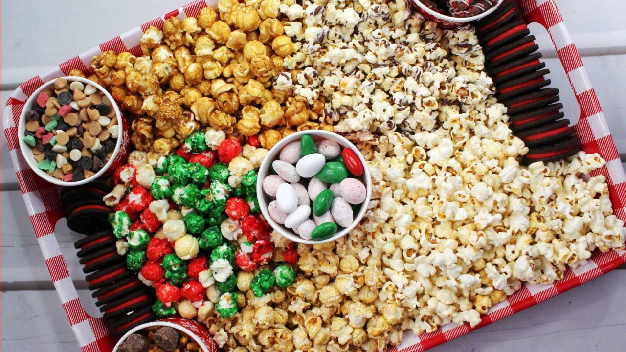 dessert charcuterie board for movie night with popcorn and candy