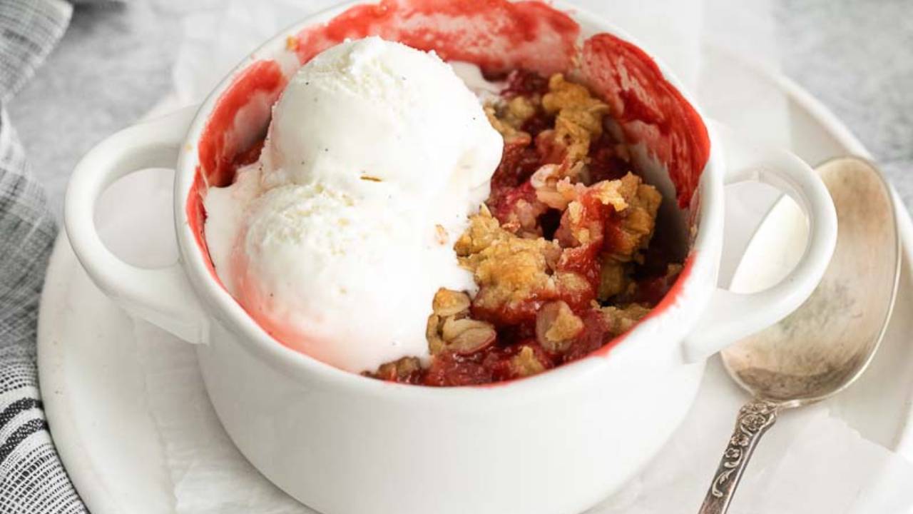 strawberry apple crisp in a dish with ice cream