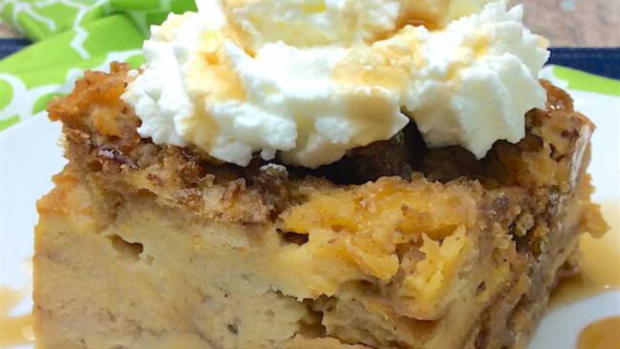 french bread pudding on a plate with whipped cream