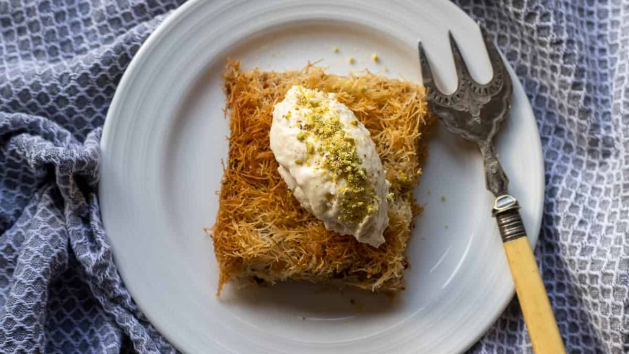 kadaif square on a plate with cream topping