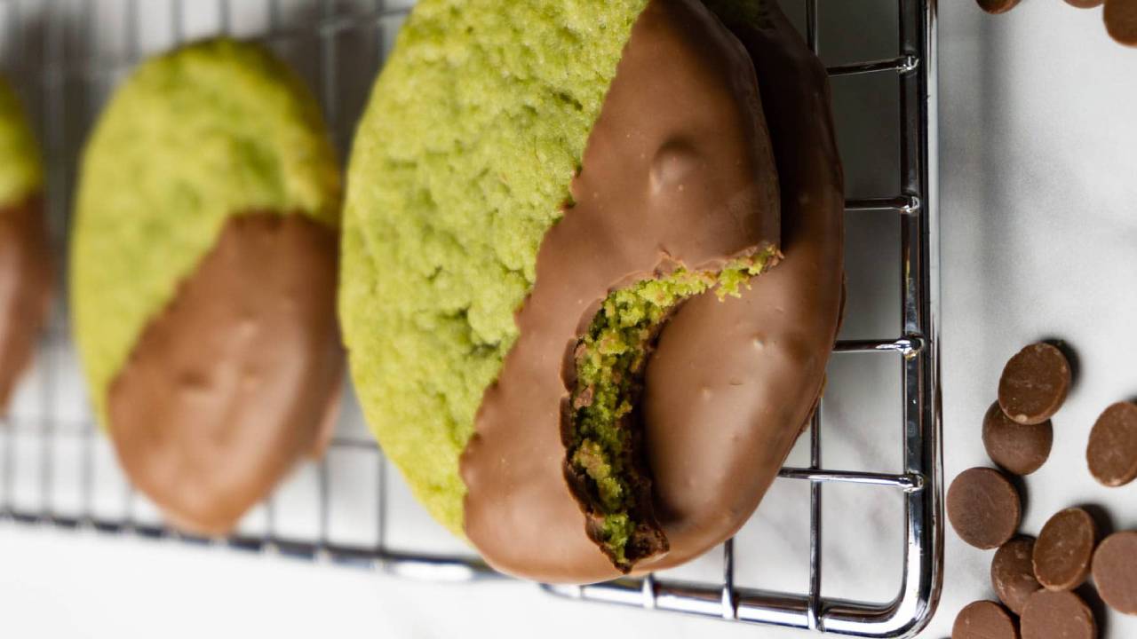 matcha cookies with chocolate on a baking rack