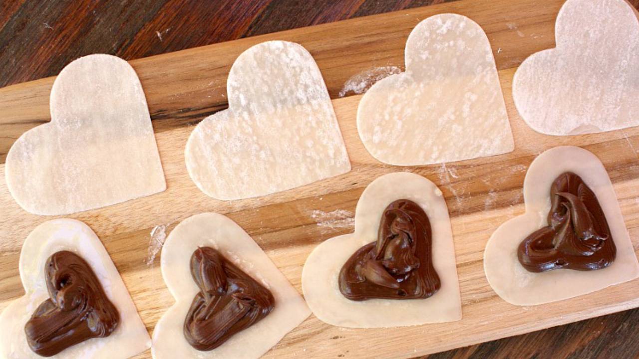 nutella heart ravioli on cutting board ready to go in oven