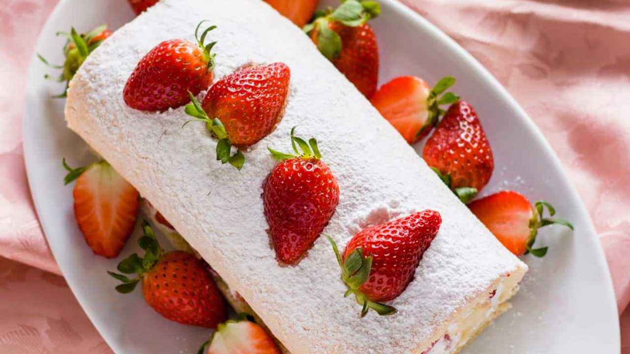 vanilla strawberry swiss roll ready to serve on a plate