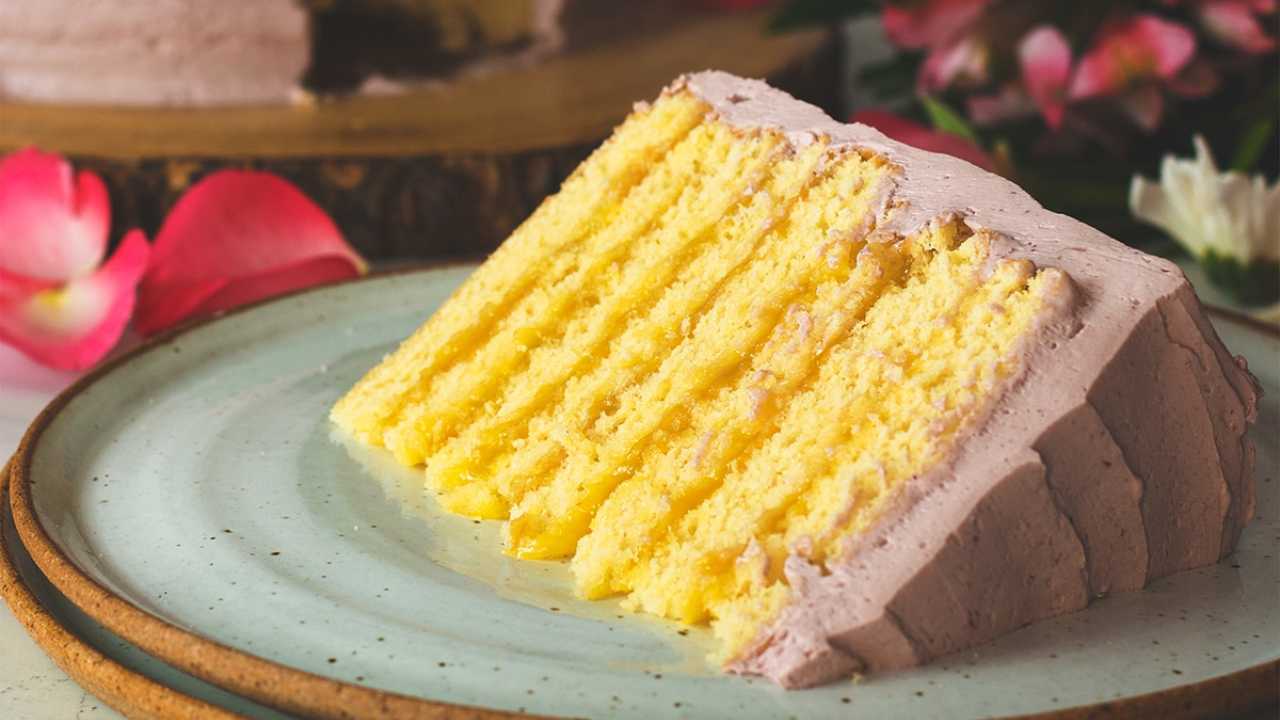 lemon layer cake with layers of blackberry buttercream