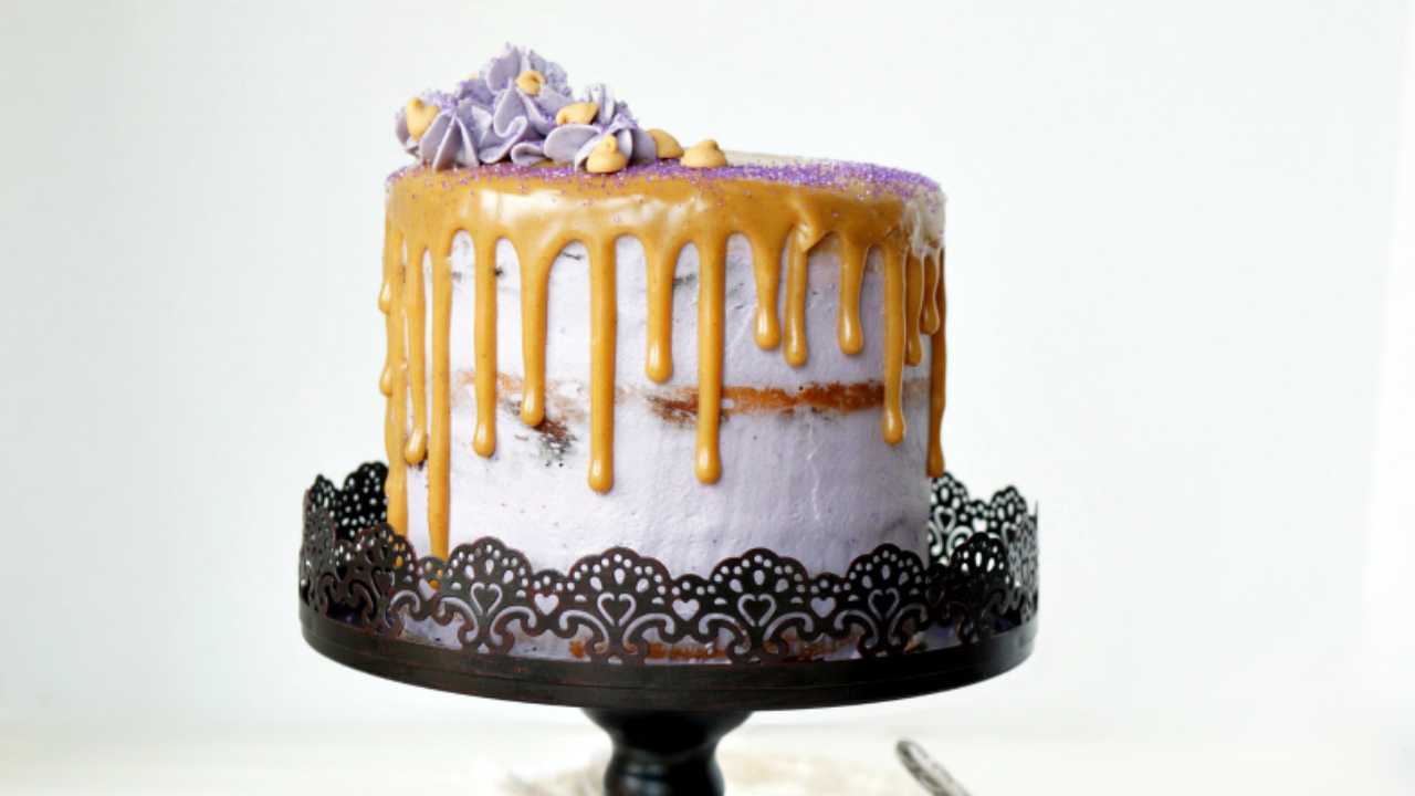 peanut butter layer cake with jelly on a cake stand